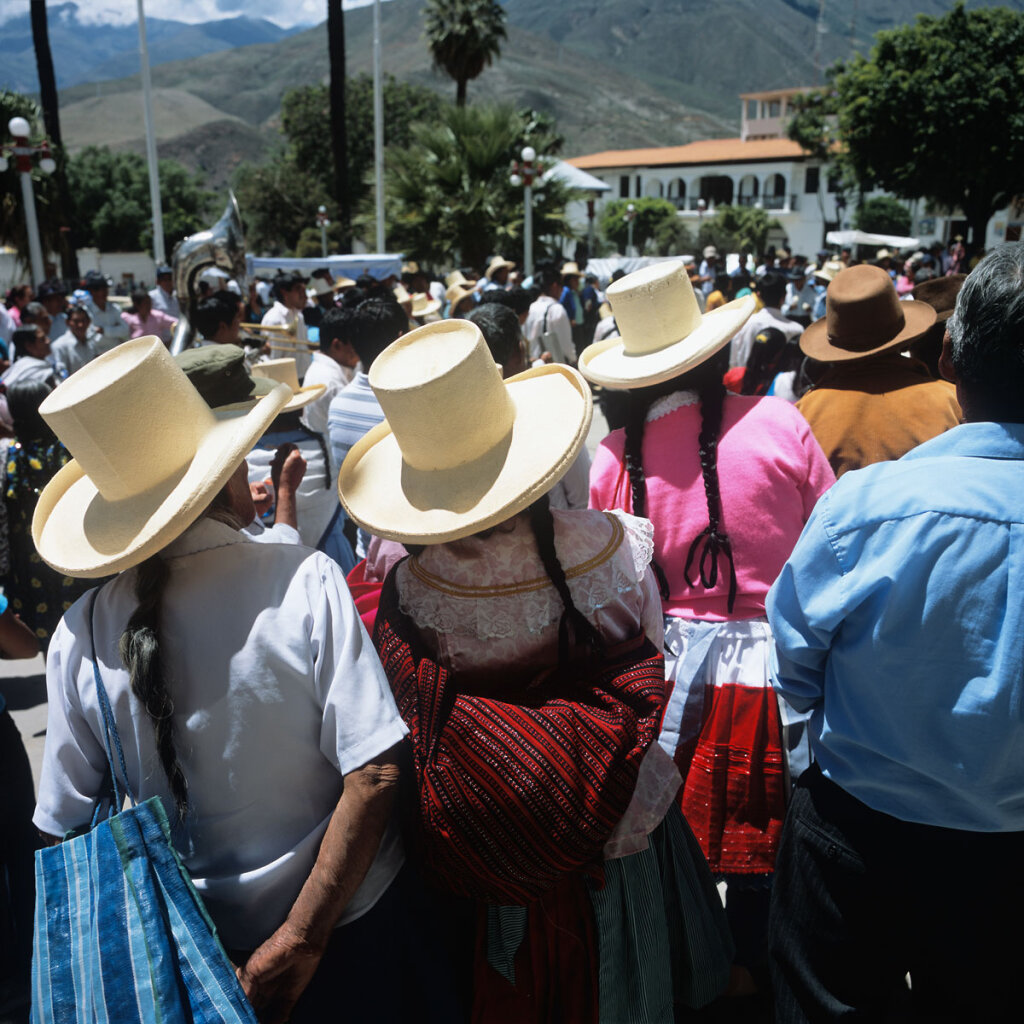 Women in tradidional clothing watching a procession