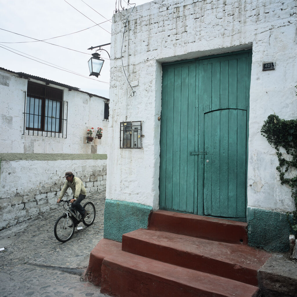 Bicycler rushing downhill on cobblestones  